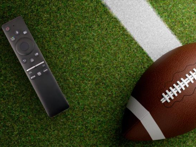 superbowl commercials, tv remote with football on turf